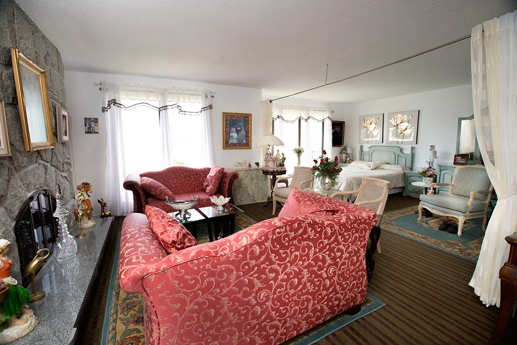 The Deluxe Suite with Ottawa River View — the residence's largest suite, with fireplace and river-facing balcony