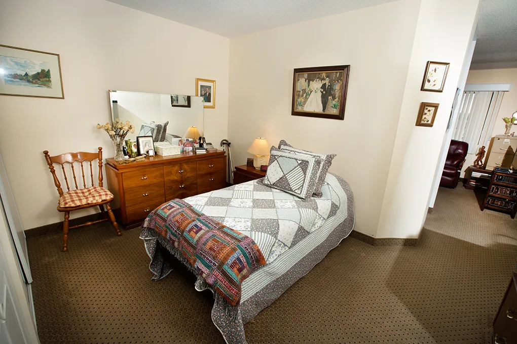 The Suite/Studio with Village View — a split suite with sitting area and village-side windows