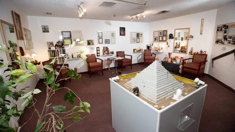The Museum of Longevity at Jardins Belle Rive, with its model pyramid, armchairs and framed exhibits