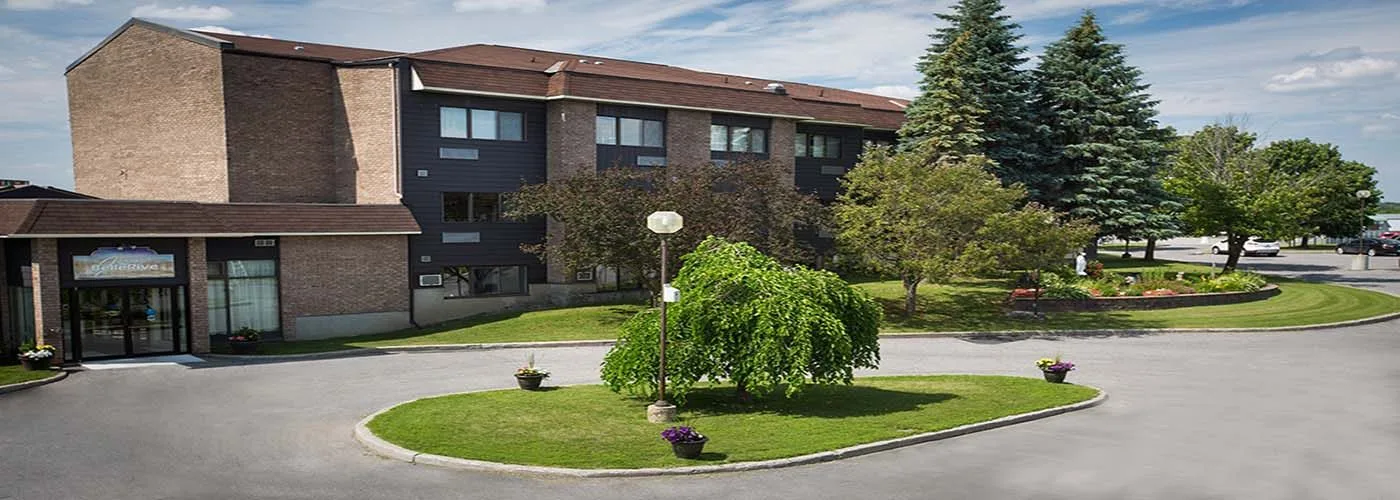 The front entrance of the residence with gardens and mature trees