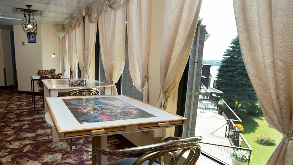 The sunroom with puzzle tables and river views
