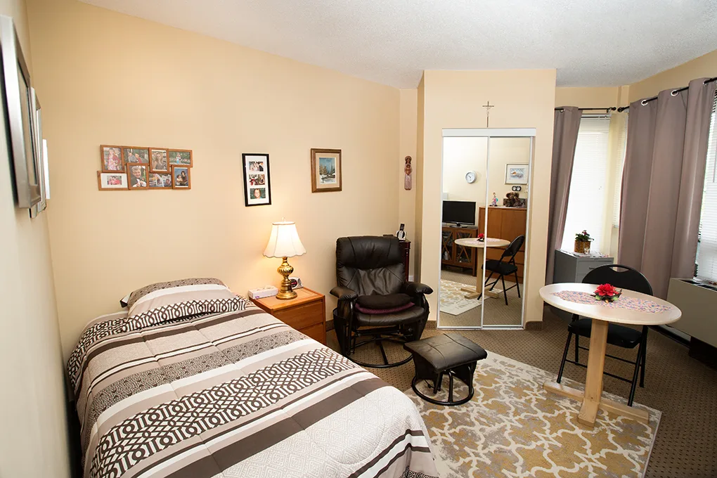 The Room with Court View — bed, mirrored wardrobe, table for two and corner windows